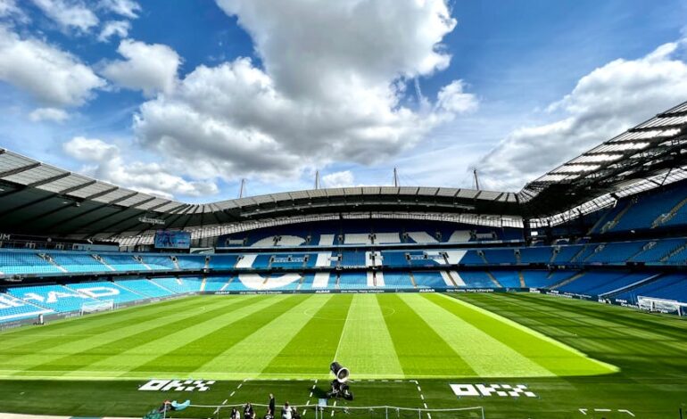 A view of the iconic Etihad Stadium in Manchester, United Kingdom, showcasing its vibrant football field.
