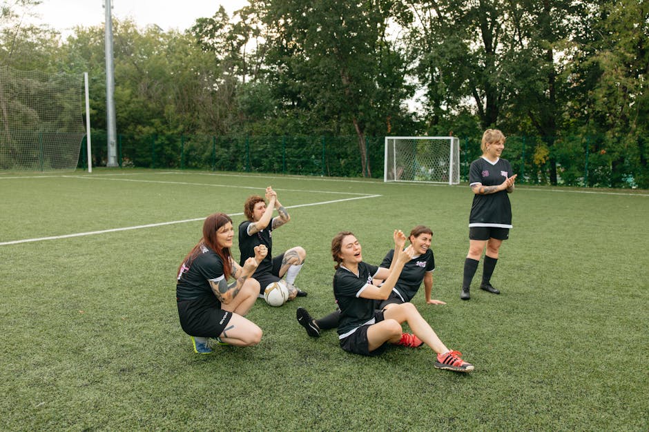 A women's soccer team celebrating joyfully on the field. Team spirit and sportsmanship.