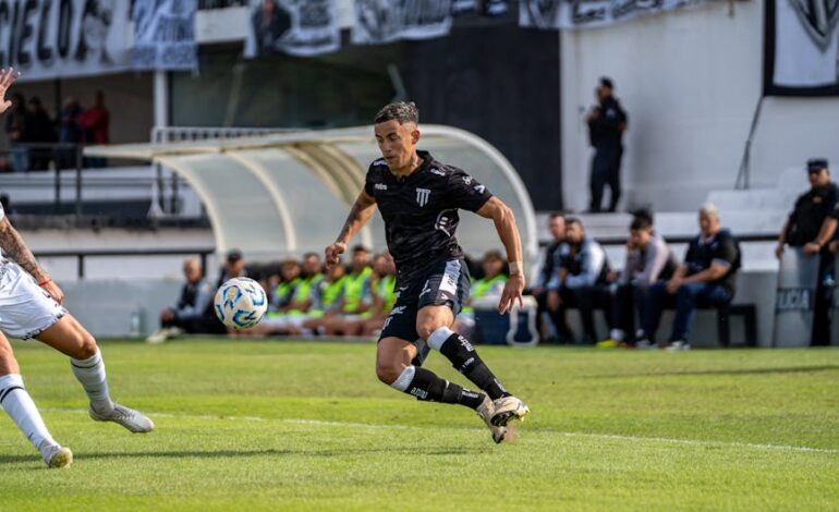 Soccer players in action during a competitive match on a sunny day.