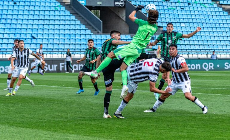 Dynamic scene of a goalkeeper leaping for the ball in a soccer match, showcasing team sports energy.