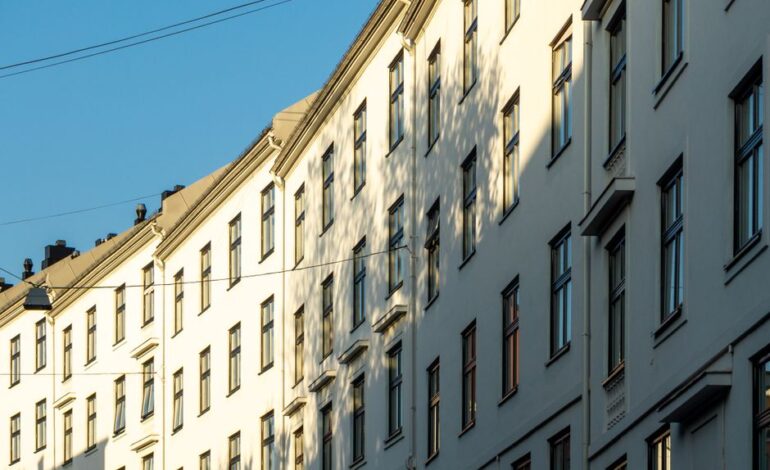 A striking angle of white residential buildings in Oslo during sunset.