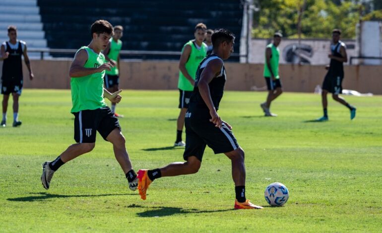 Soccer players in action during a training session on a bright sunny day.