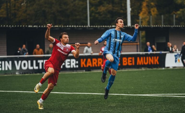 Two soccer players in action during a competitive match on a green field.