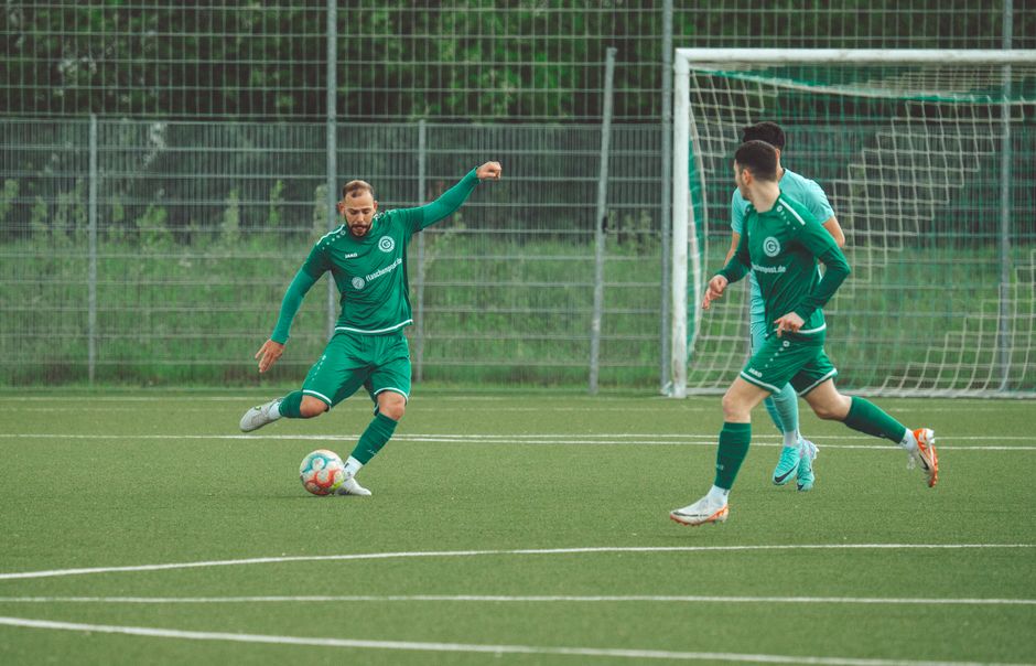 Players in green uniforms engage in a dynamic soccer match on a grassy field.
