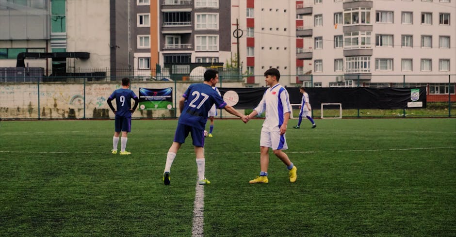 Soccer players shaking hands on an urban pitch in Tirebolu, Türkiye.