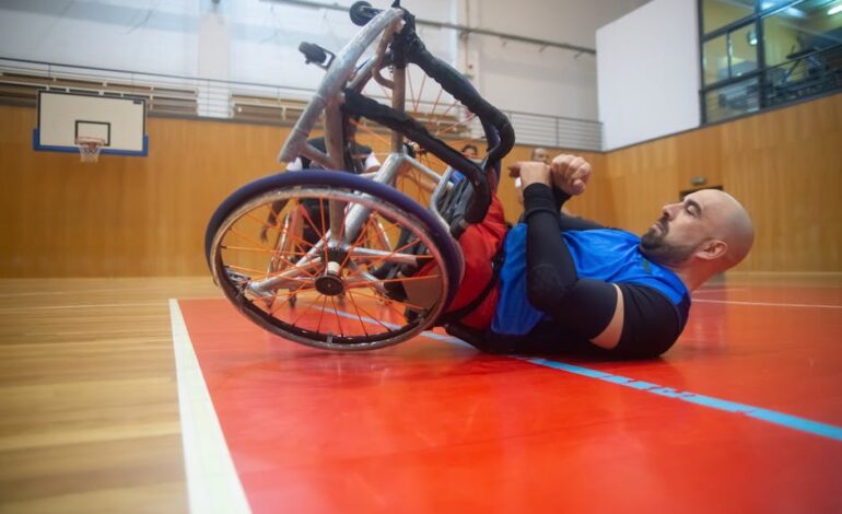 An athlete in a wheelchair practices basketball indoors, showcasing determination.