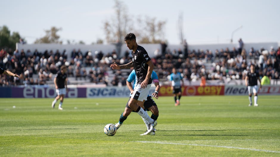 Exciting soccer game with players in action on a sunny day outdoors.